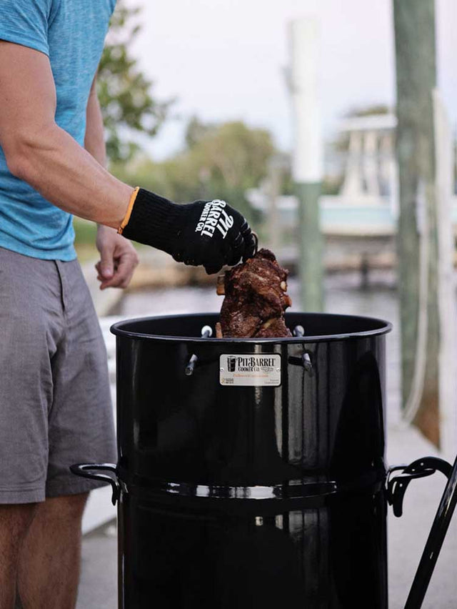 Pulling-Lamb-from-Vertical-Cooker-With-Gloves-Pit-Grips