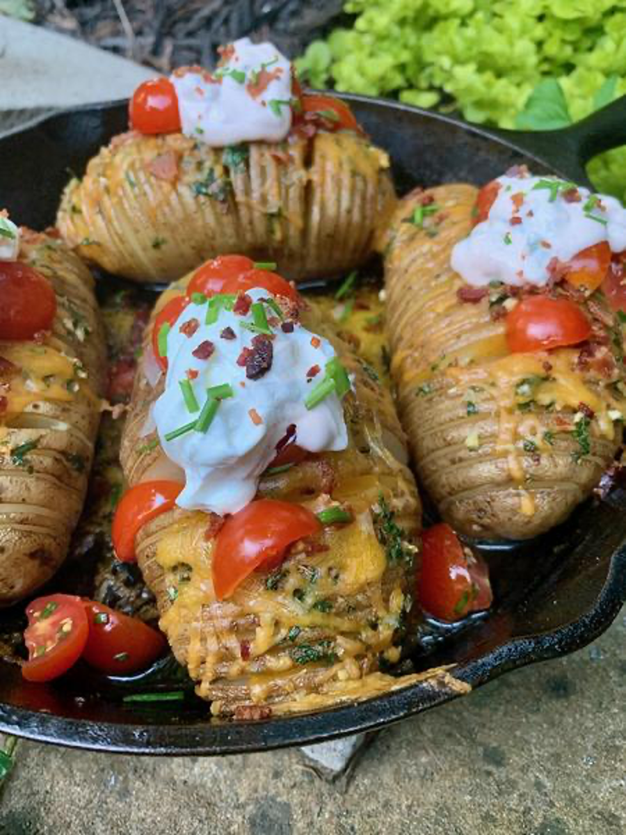 Smoked Hasselback Potatoes Topped with Chive Salsa and Jalapeño Sour Cream in Cast Iron
