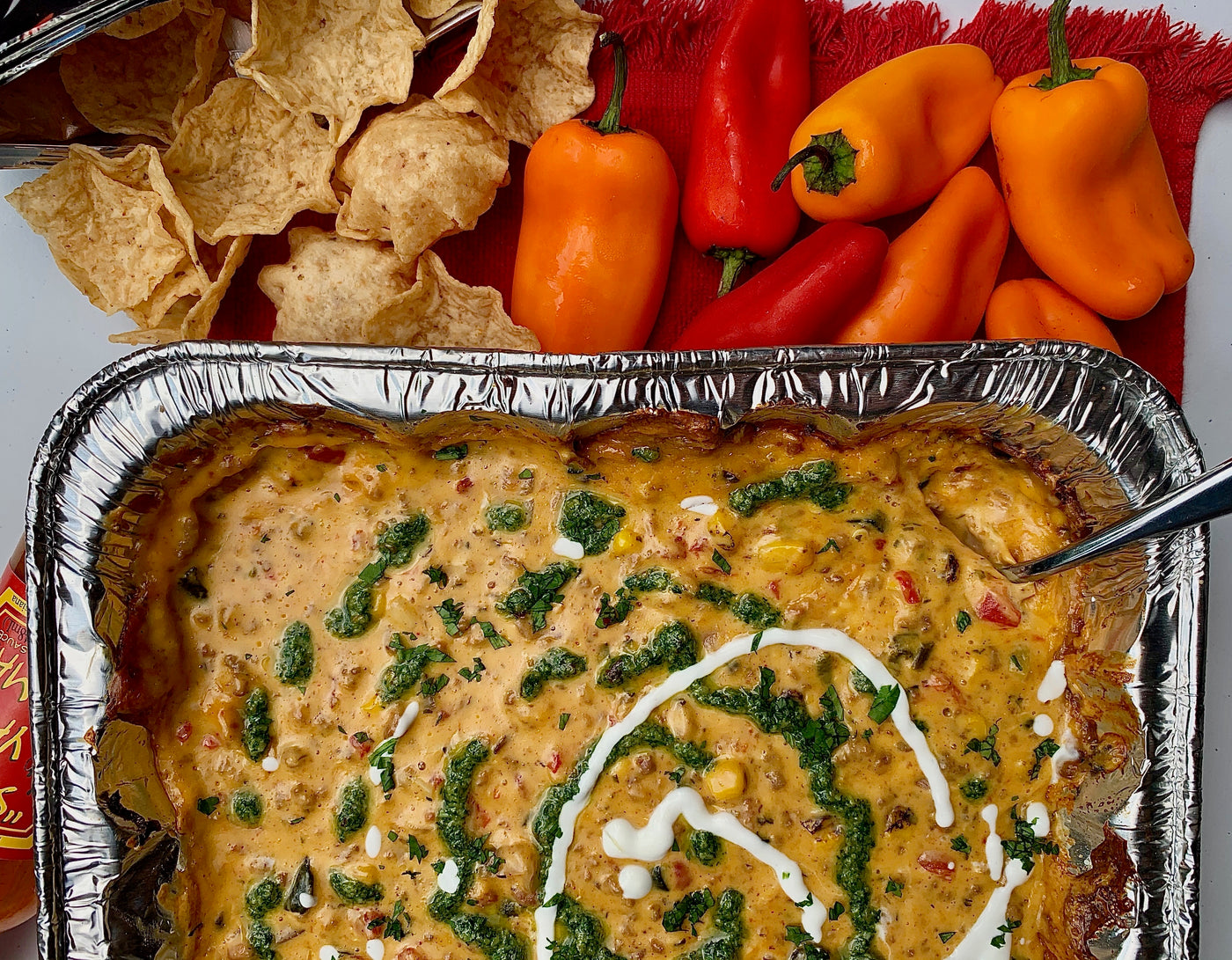 Pan of Roasted Queso Dip with Peppers and Nachos