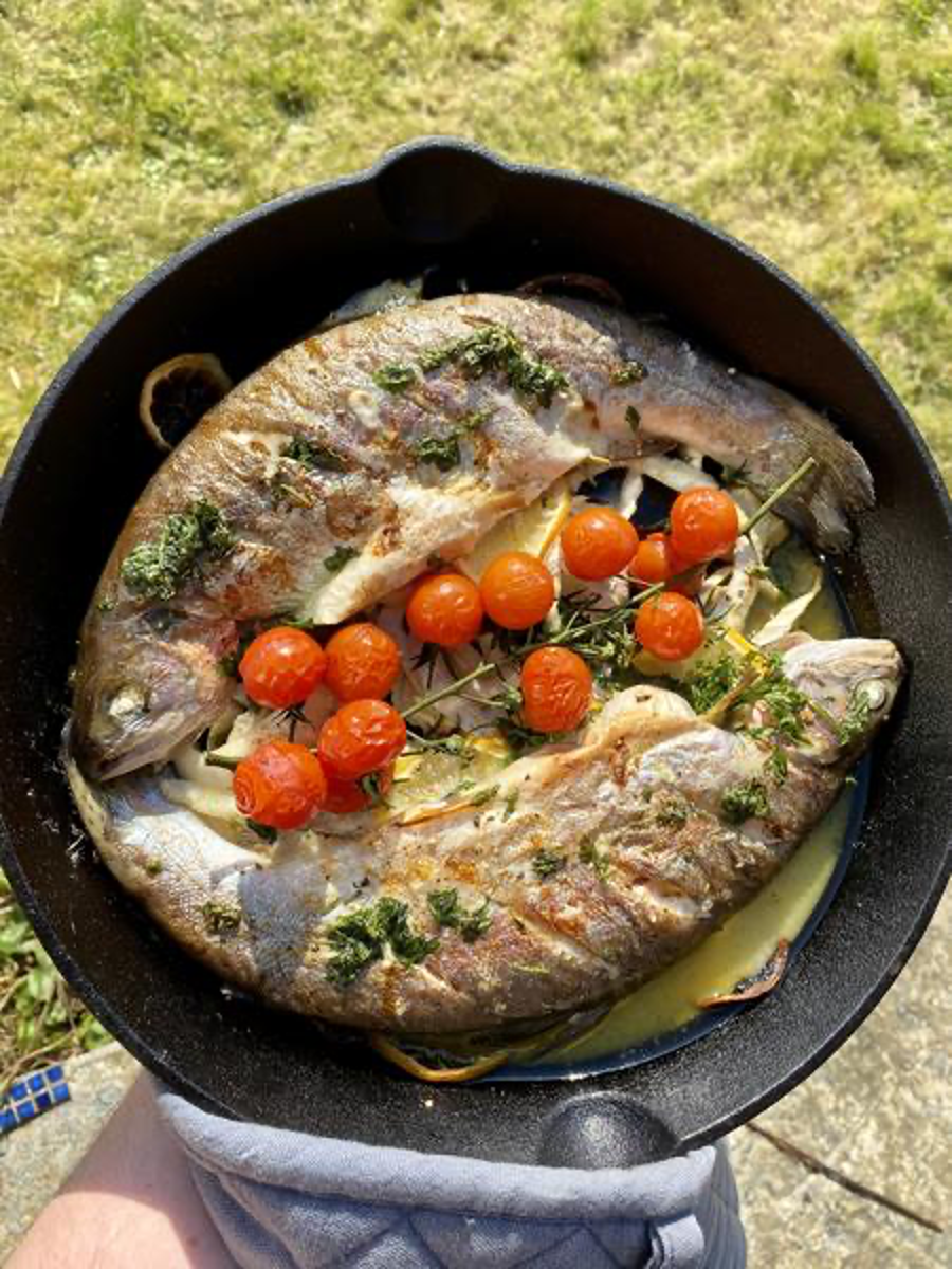 Two Smoked Whole Rainbow Trout in Cast Iron with Cherry Tomatoes and Herbs