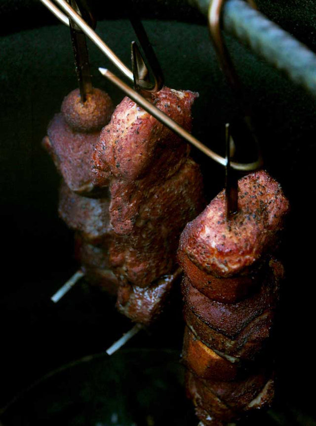 Meat-In-Barrel-Cooker-Hanging-On-Skewers
